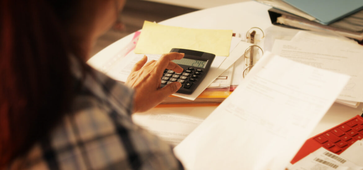 Old people, tax return and home banking. Senior woman paying federal taxes, doing family budget. Elderly person typing on calculator. Concept of money, finance, financial problems