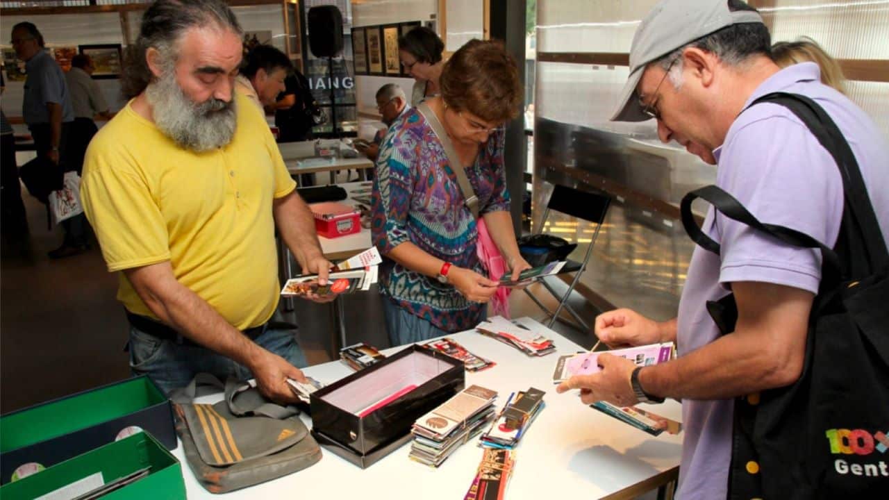 Three people trading items services at a table