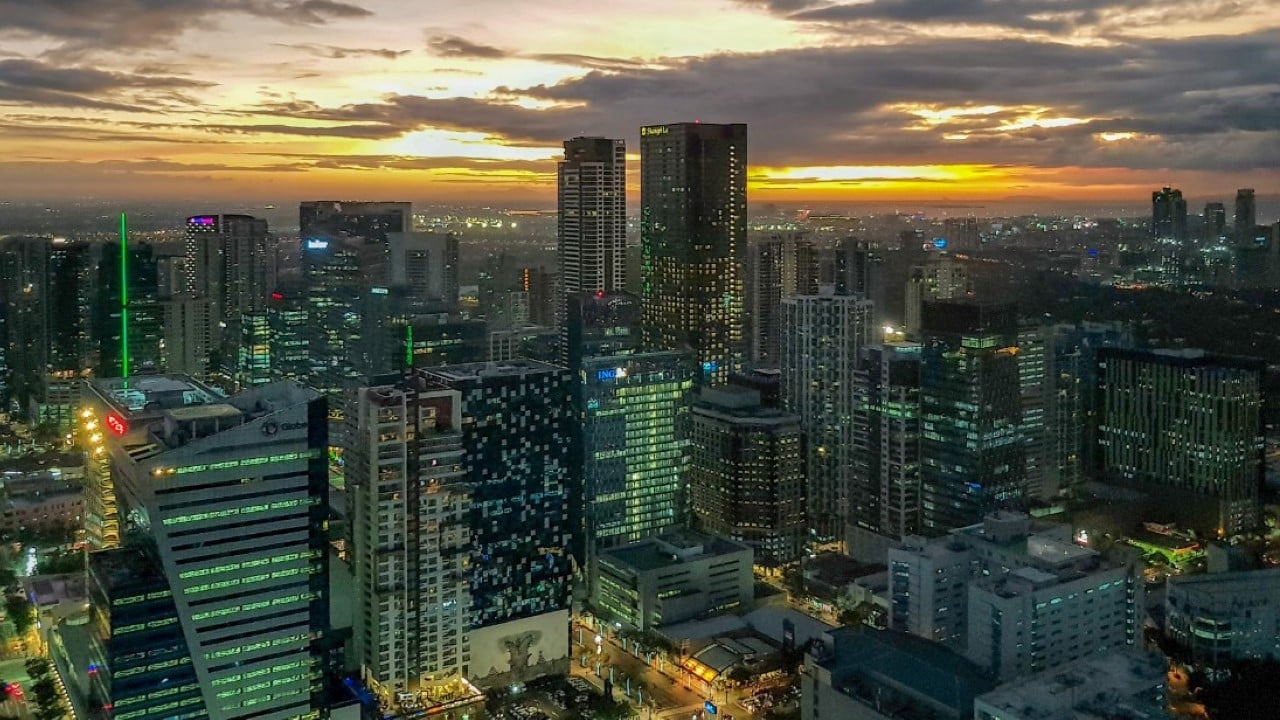 View from Grand Hyatt Manila overlooking Bonifacio Global City and Makati skylines at sunset