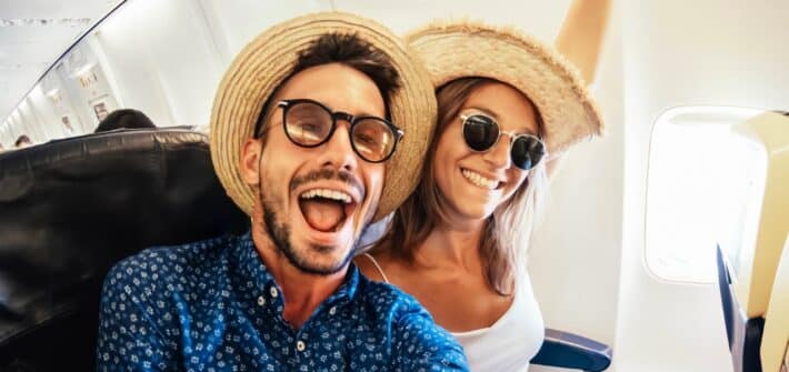 Happy,Tourist,Taking,Selfie,Inside,Airplane,-,Cheerful,Couple,On