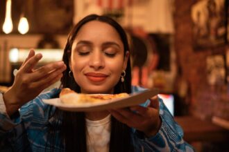 happy tourist breathing in food
