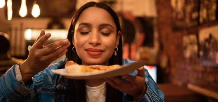 happy tourist breathing in food