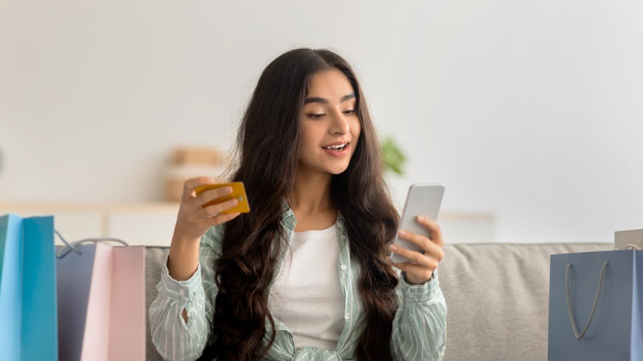 Woman using credit card to shop