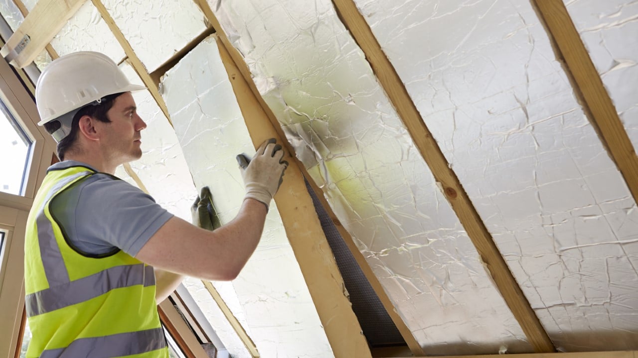 Person installing insulation.