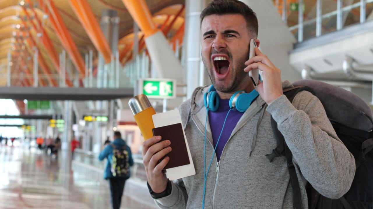 Upset man at an airport.