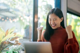 Woman celebrating improvement of her credit score and debt consolidation