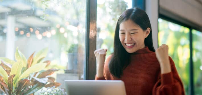 Woman celebrating improvement of her credit score and debt consolidation