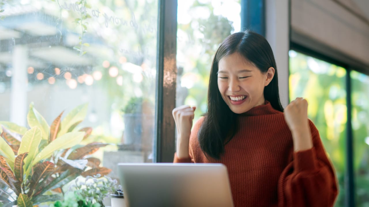 Woman celebrating improvement of her credit score