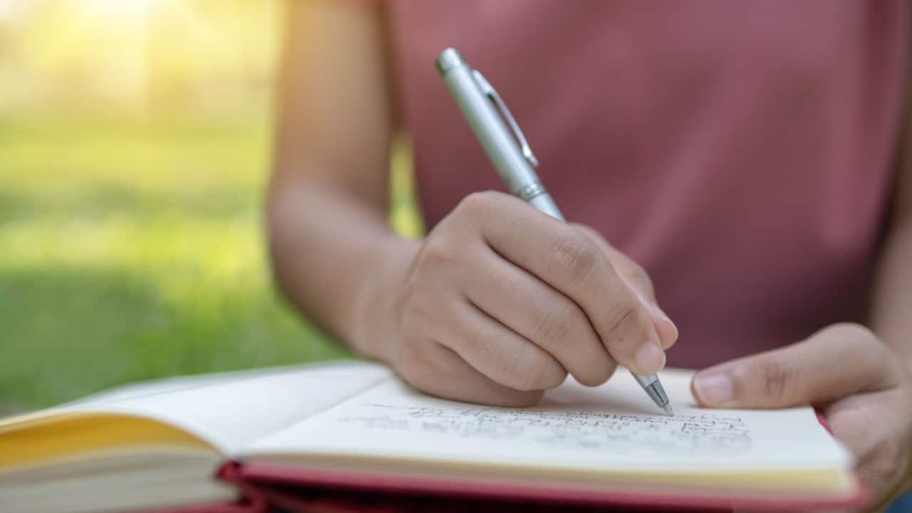 Woman writing in notebook