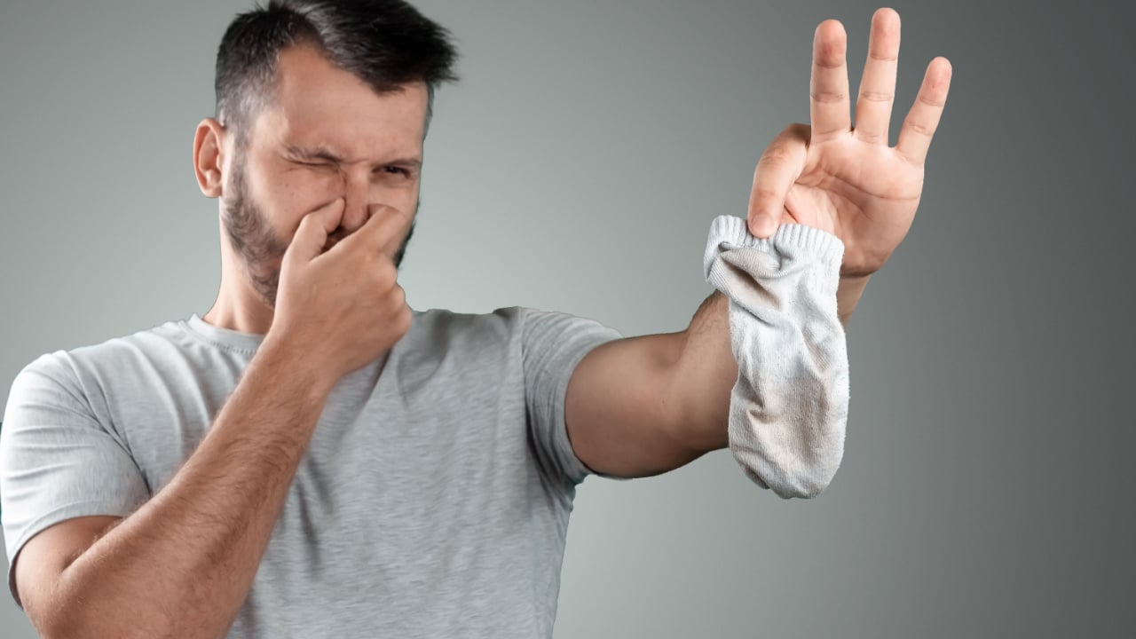 Man holding smelly sock