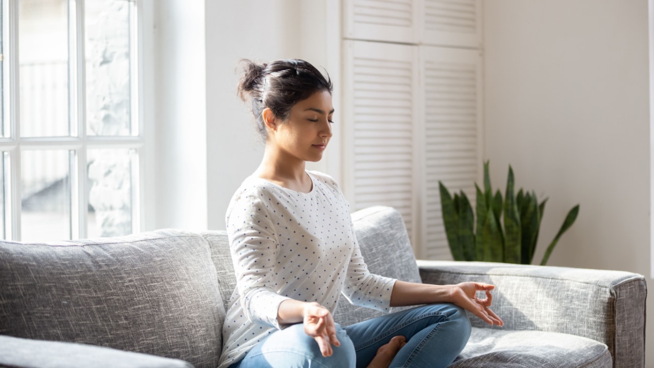 Woman mediating on the couch