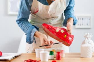 Woman painting a shoe.