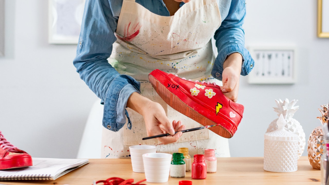 Woman painting a shoe.