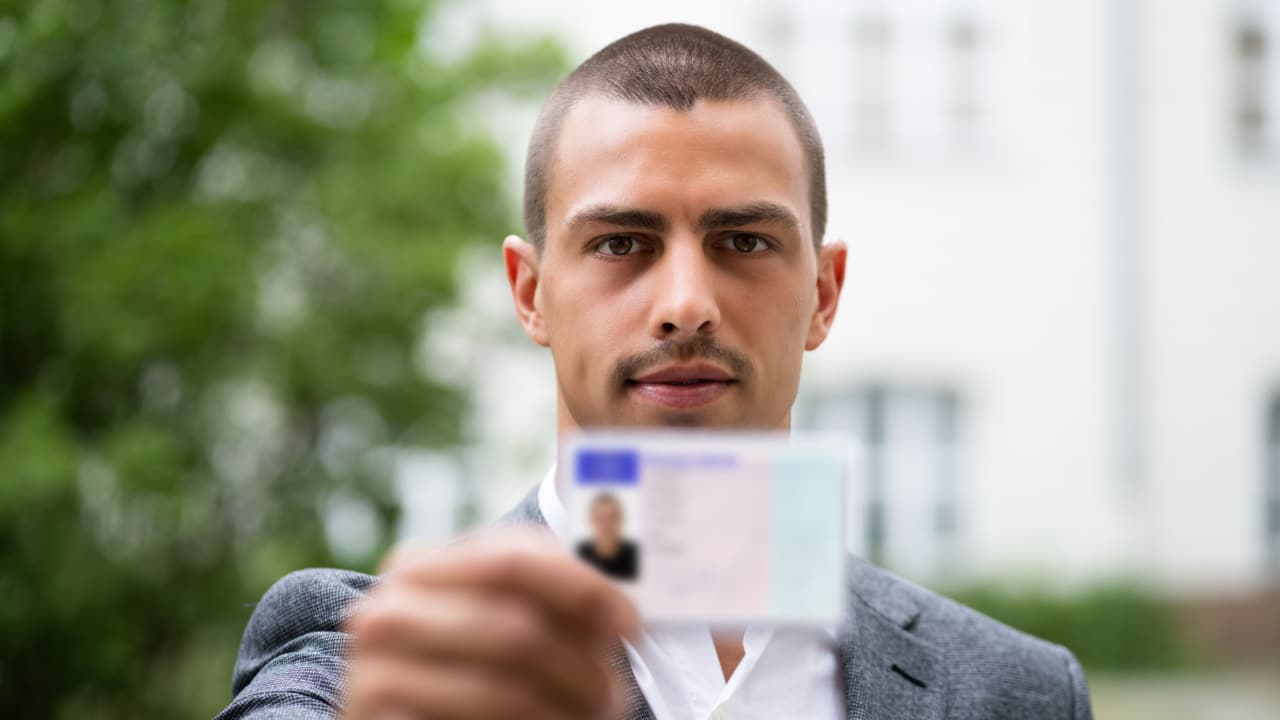 Man holding identification card