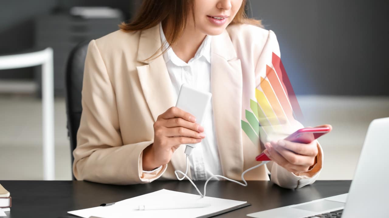 Woman charging phone with powerbank