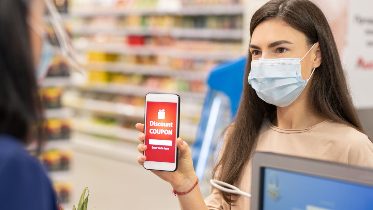 Woman using coupons to buy her groceries