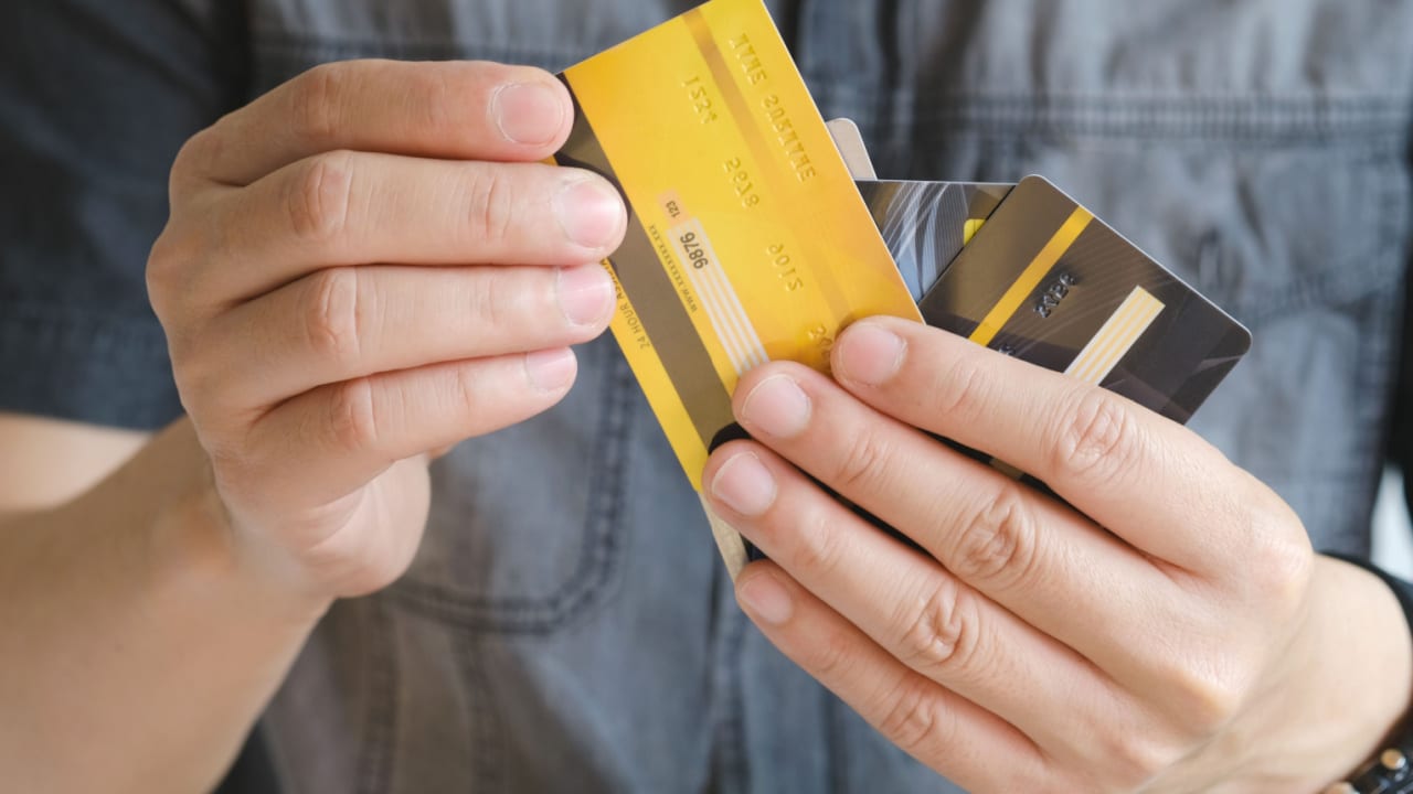 Man holding multiple credit cards