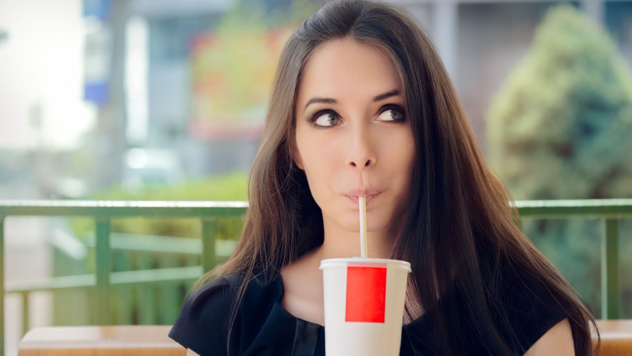 Woman drinking from a straw.