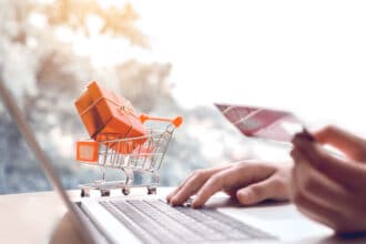 Person using credit card for online order, reward item in trolley