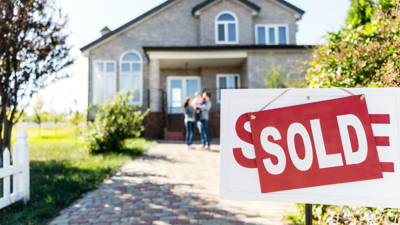 Nice house with sold sign out front