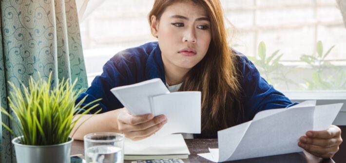 Tired Woman Looking At Bills