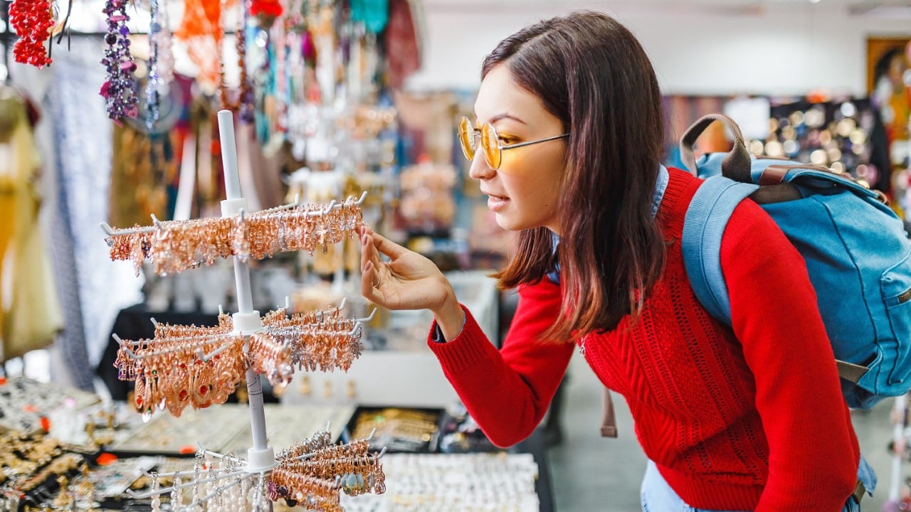 Asian woman buying jewelry at shopping store