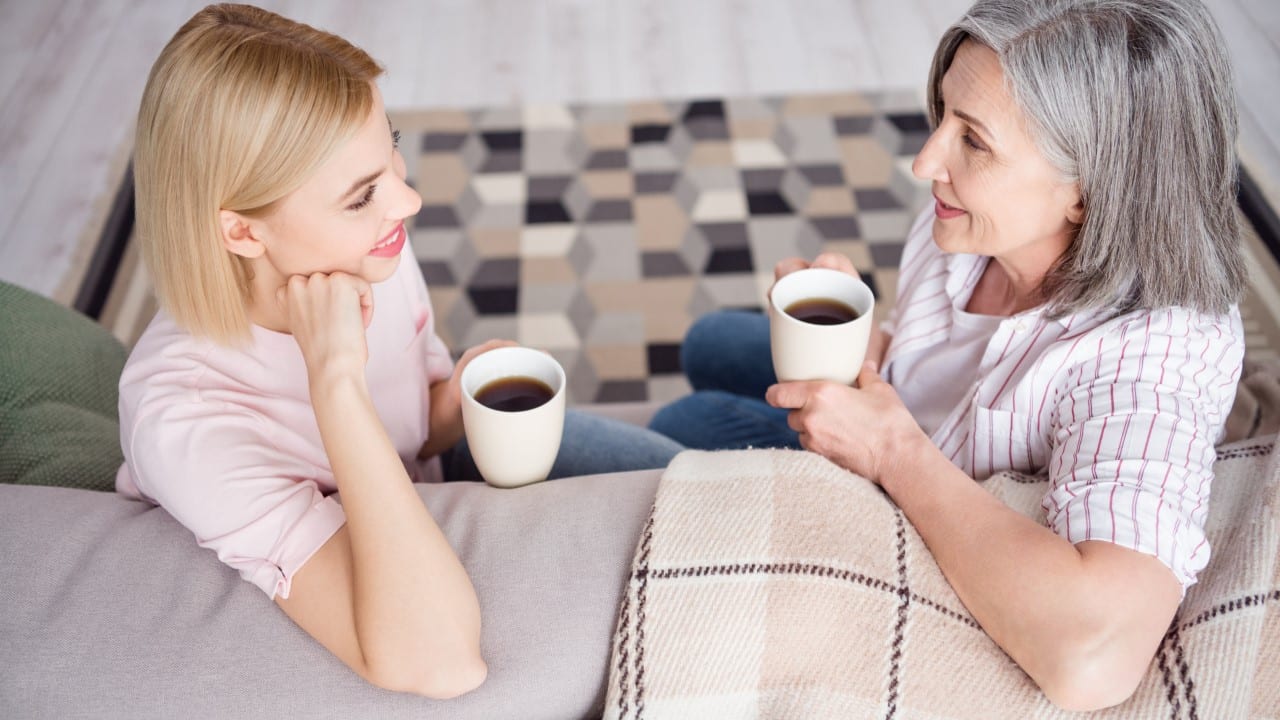 two women drinking coffee talking