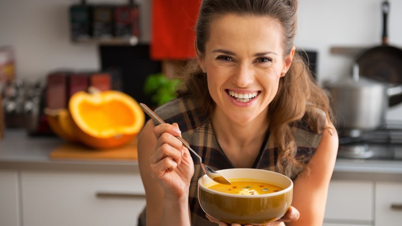 Woman enjoying soup from left over ingredients