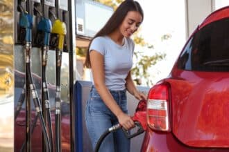 Woman putting fuel in car