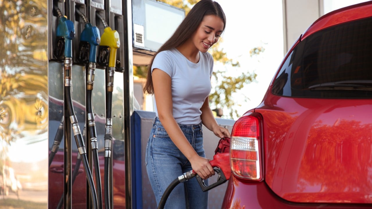 Woman putting fuel in car