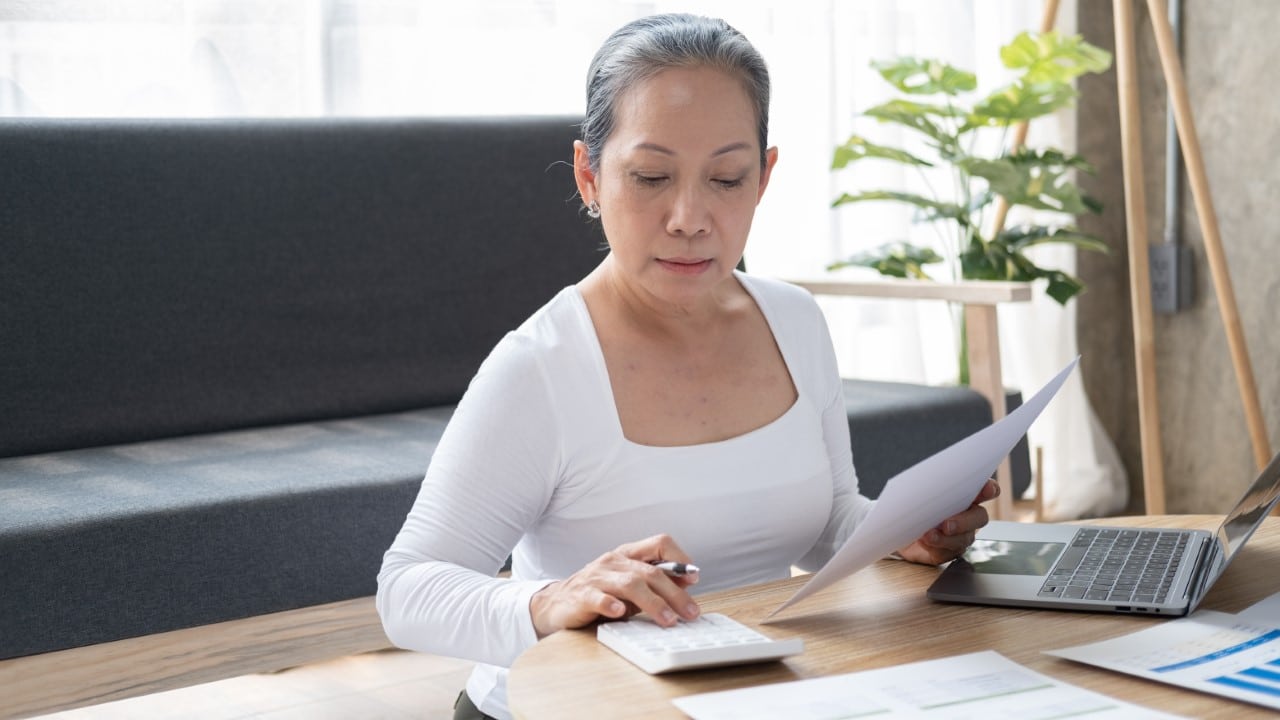 Woman making notes and updating personal information