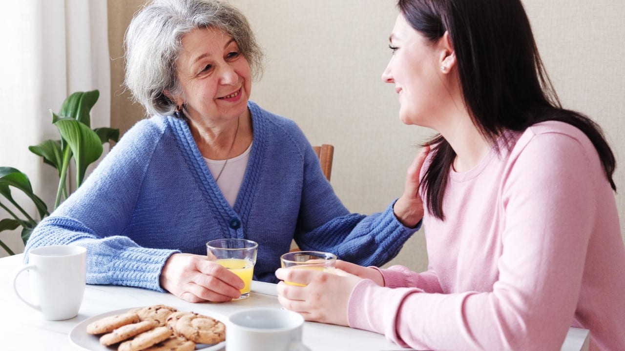 women talking over breakfast, mother and daughter