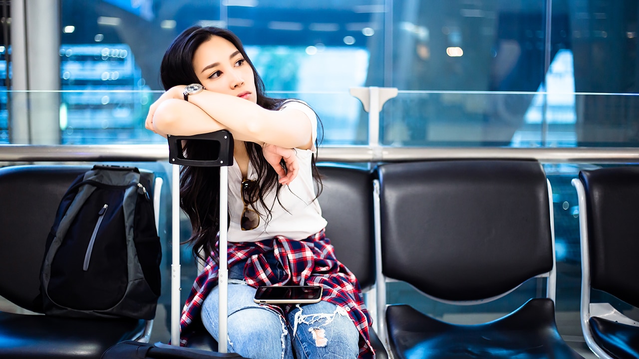 delayed flight, woman waiting for flight