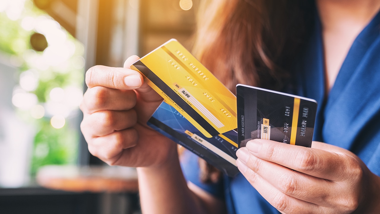 Closeup image of a woman holding and choosing credit card to use