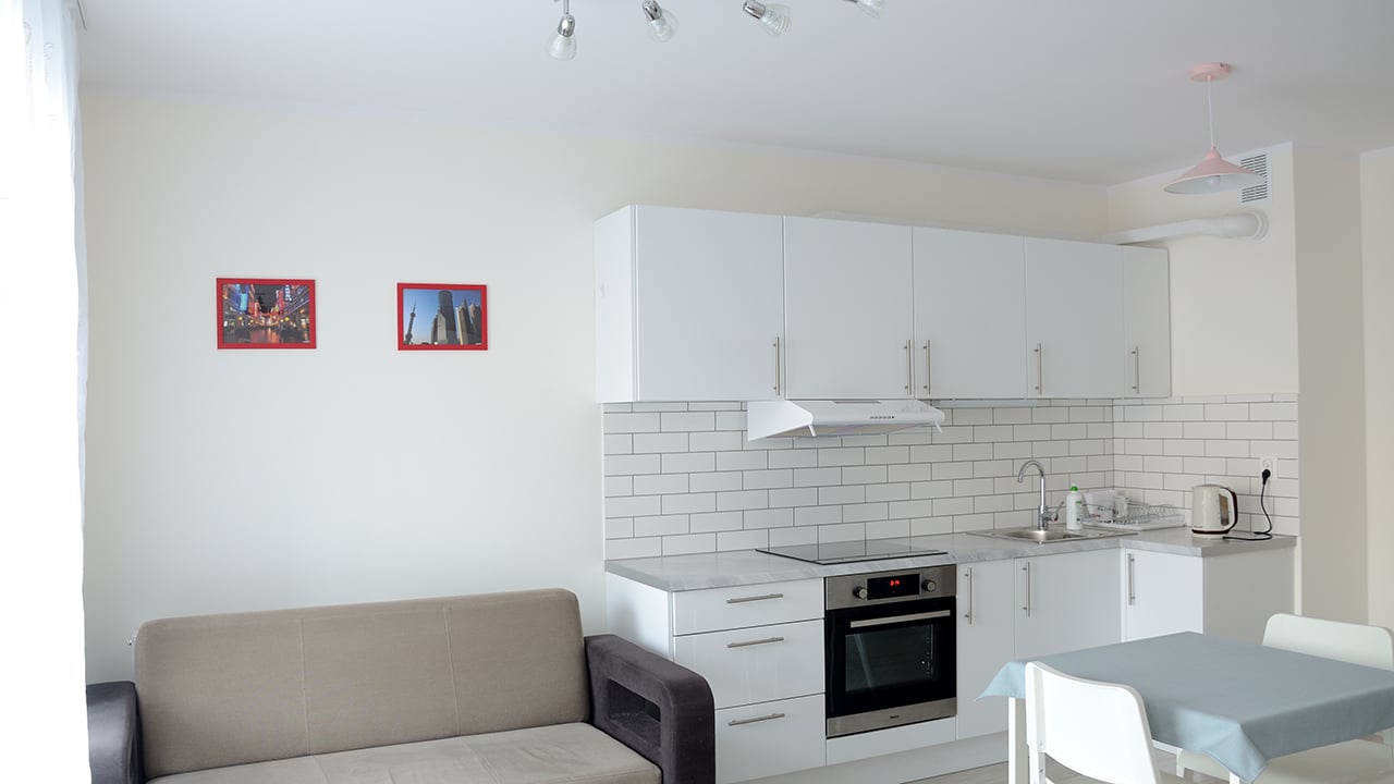 New apartment with white kitchenette in Wroclaw, Poland. Studio type apartment
