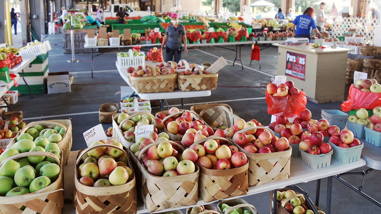 Workers and customers at the State Farmers Market