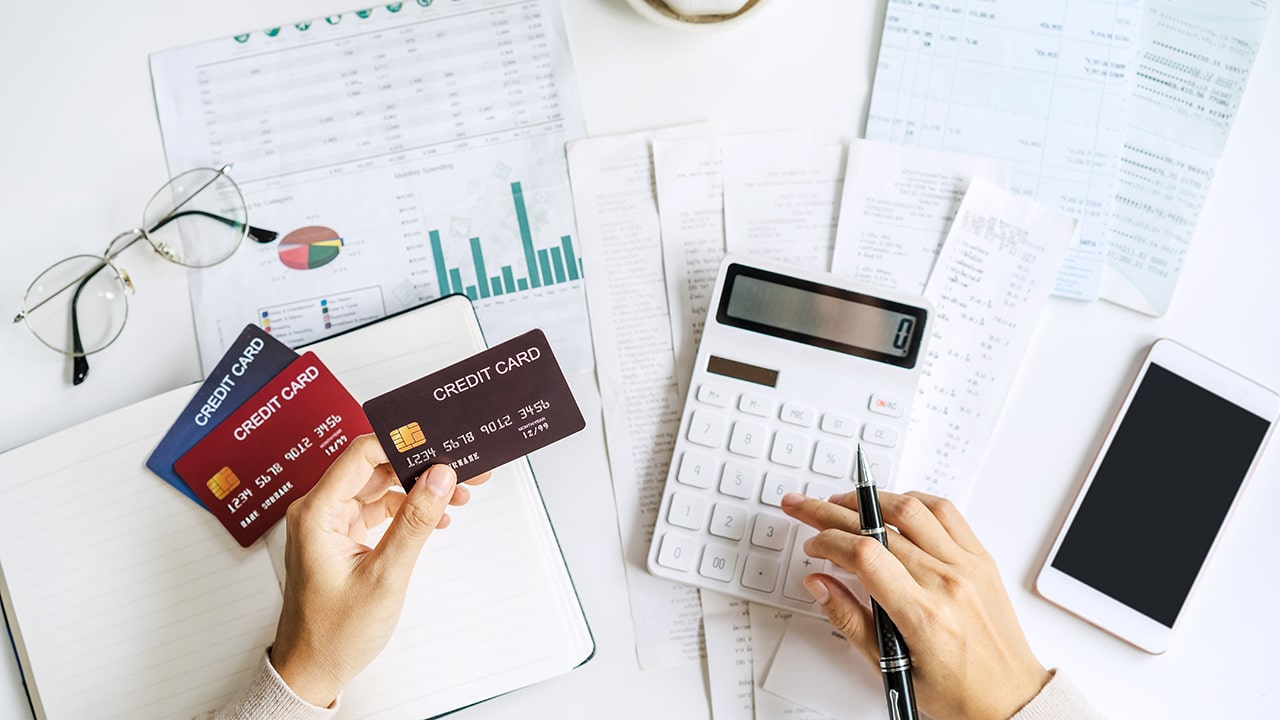 Stressed young woman calculating monthly home expenses, taxes, bank account balance and credit card bills payment, Income is not enough for expenses