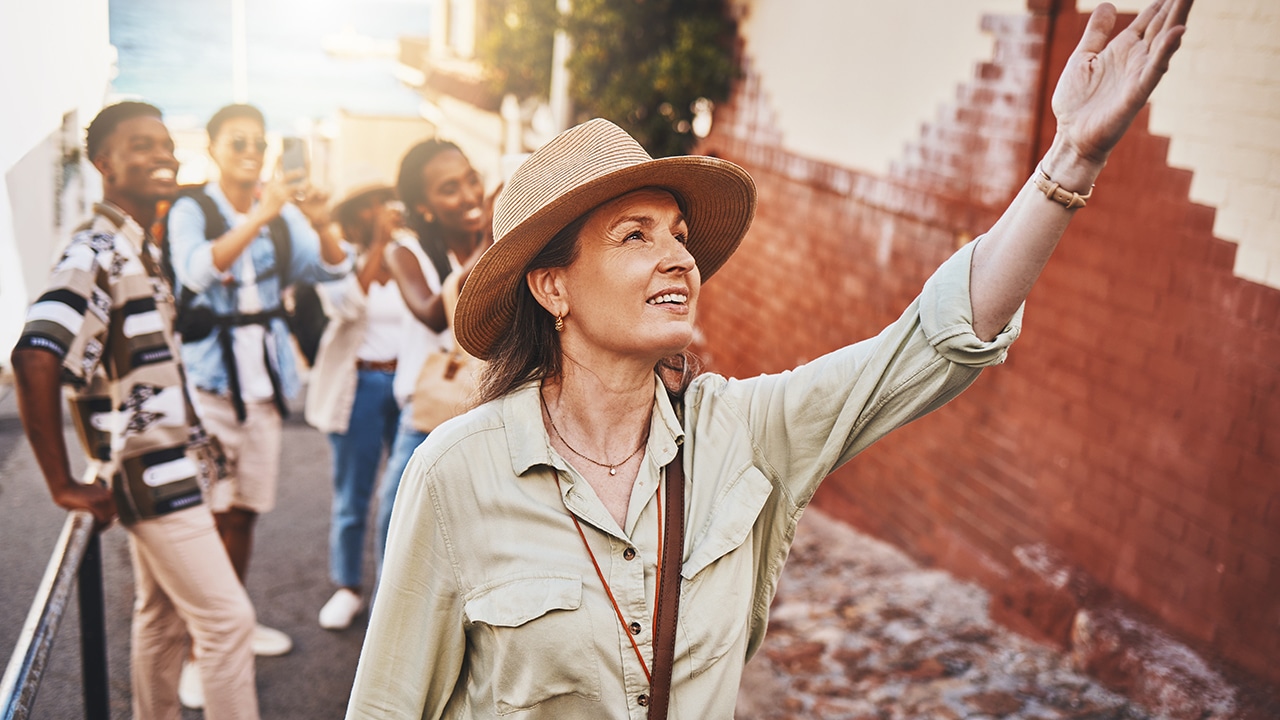 Group on walking tour with guide pointing out various things to learn about and see