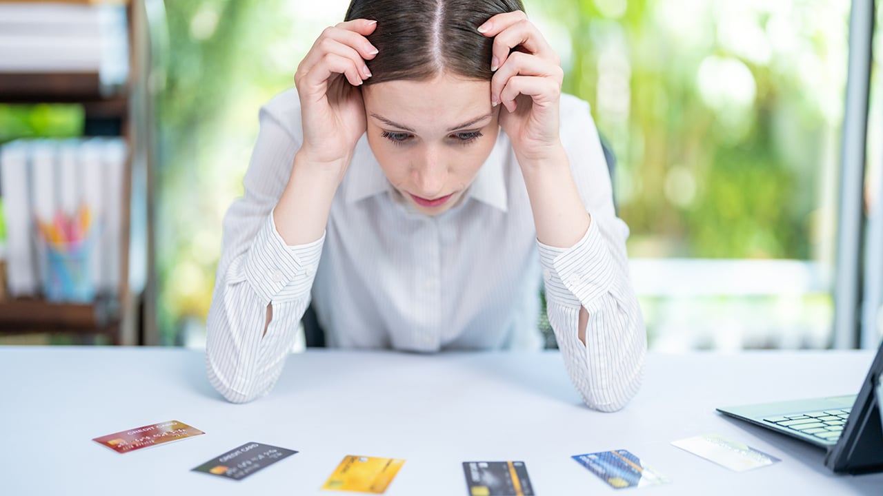 Desperate frustrated bank client woman facing scam, overspending, problems with online payments, blocked credit card, bankruptcy, Stressed woman hold credit card calculating monthly home expenses