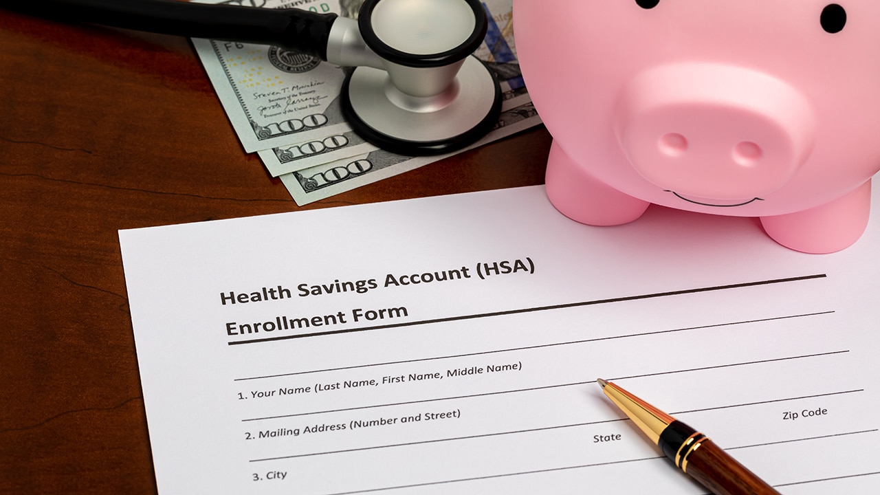 Health savings account, HSA, form with stethoscope, piggy bank and cash money. Health insurance, medical and dental healthcare costs concept.