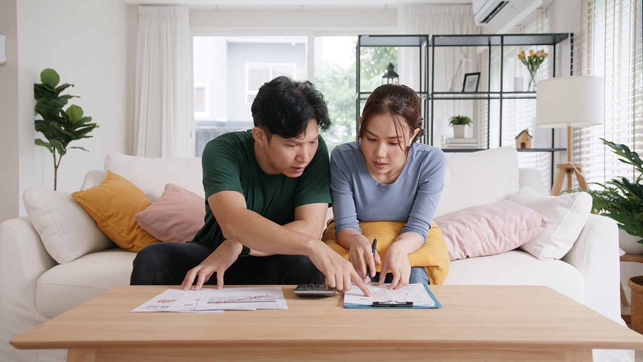 Couple sitting down together working on their budget