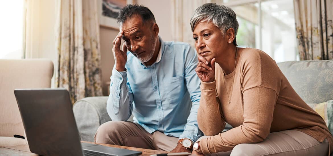 Senior couple, stress and laptop for financial debt, budget mistake and investment fail or asset management at home. Elderly people with depression, thinking or reading news or email on computer