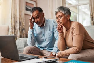 Senior couple, stress and laptop for financial debt, budget mistake and investment fail or asset management at home. Elderly people with depression, thinking or reading news or email on computer