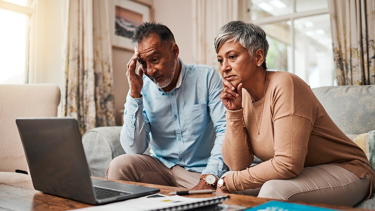 Senior couple, stress and laptop for financial debt, budget mistake and investment fail or asset management at home. Elderly people with depression, thinking or reading news or email on computer