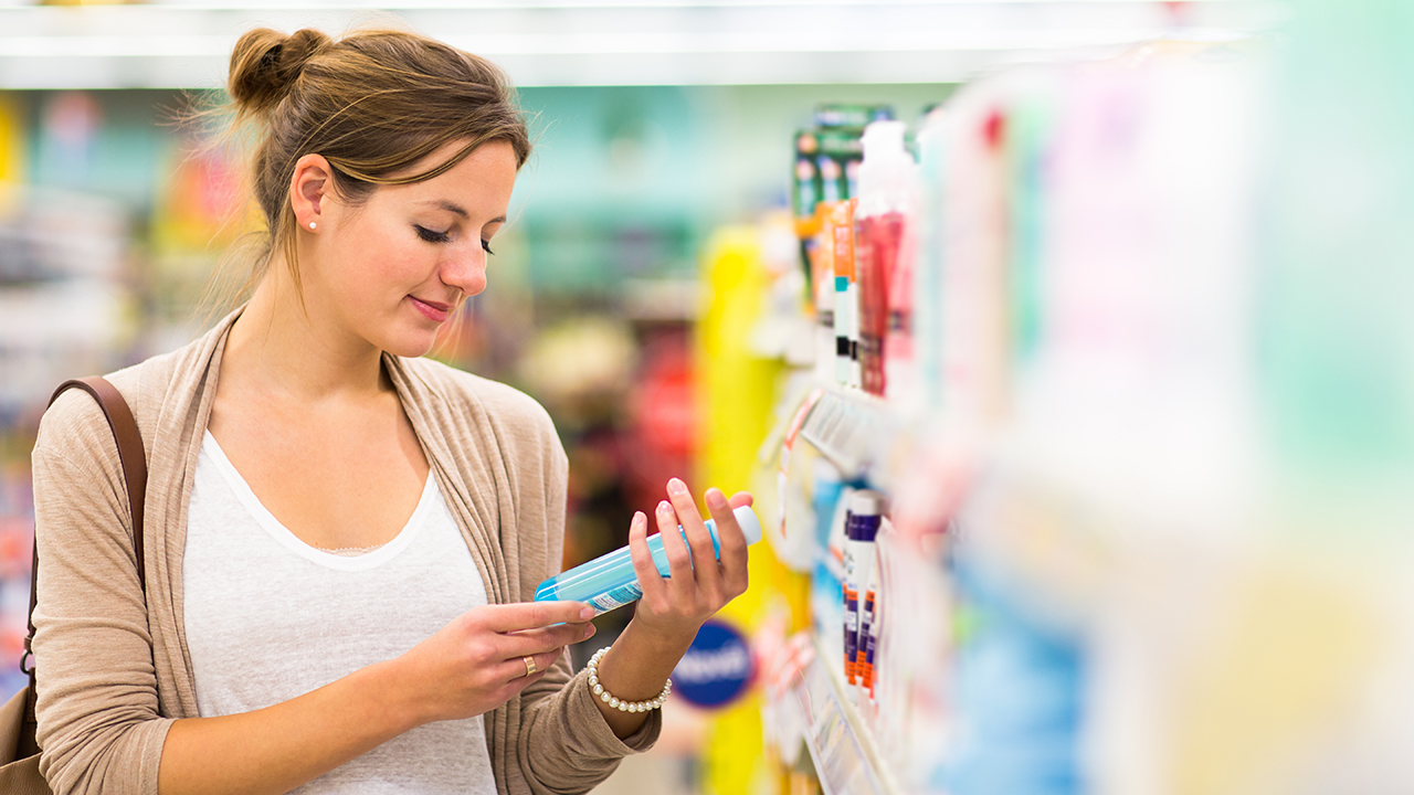 Beautiful young woman shopping in a grocery store/supermarket 