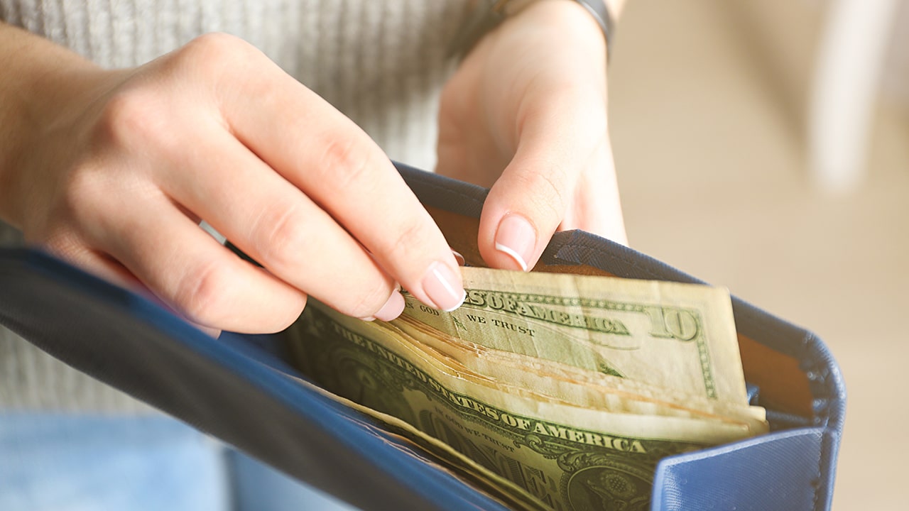 Girl with blue wallet full of money