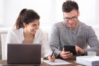 Happy couple looking at finances.