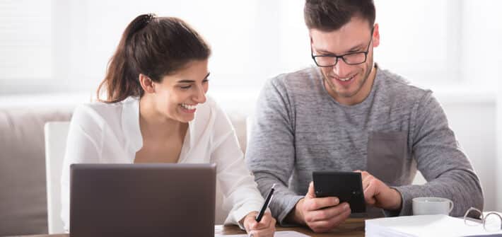 Happy couple looking at finances.