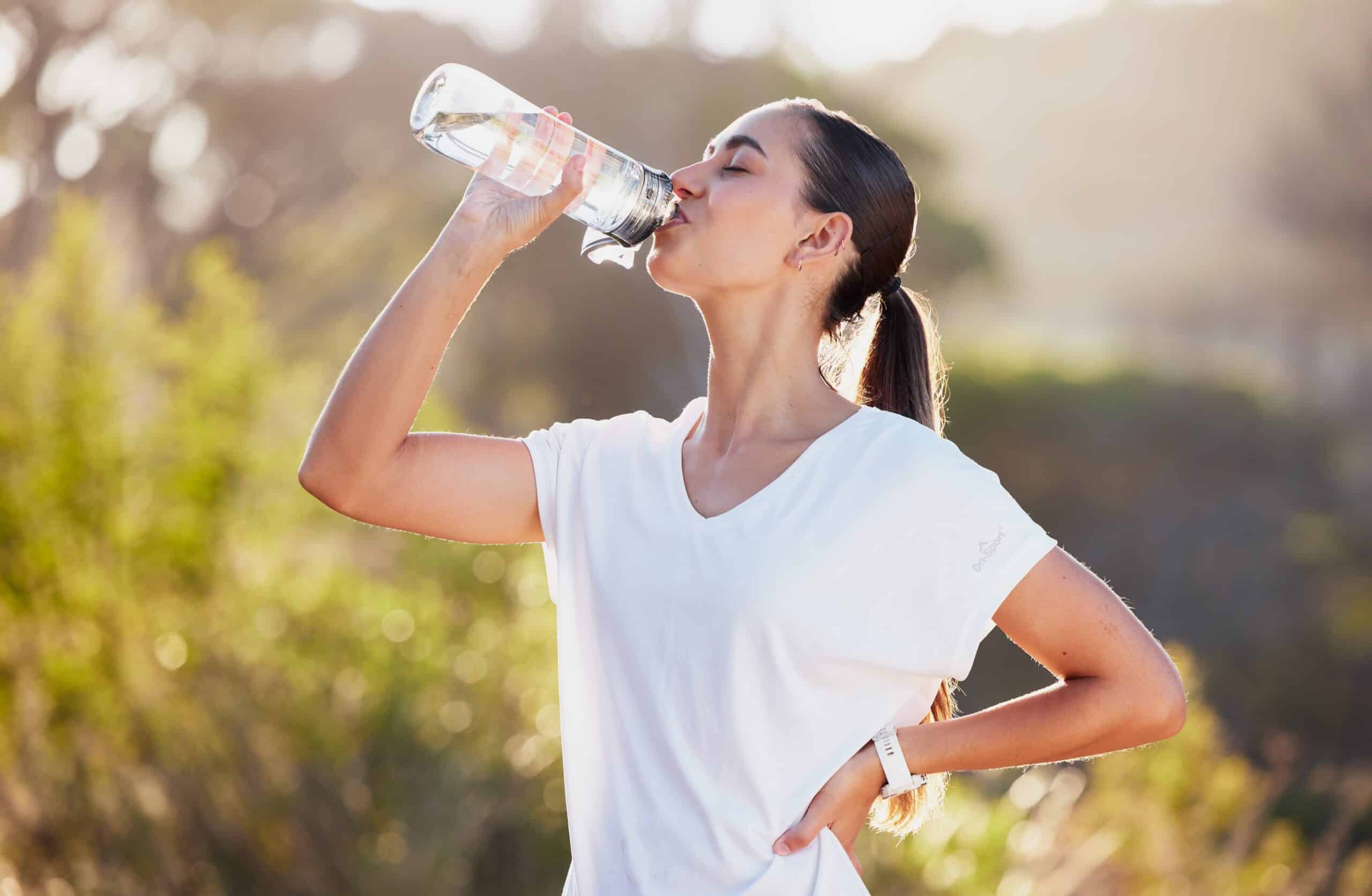 Woman drinking out of water bottle