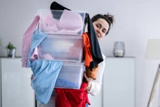 Woman Decluttering And Doing Laundry At Home Organizing